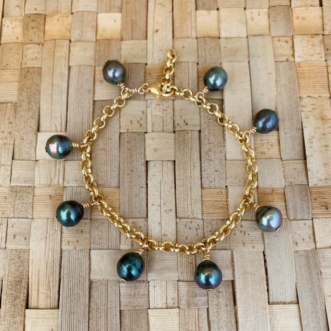 tahitian pearl bracelet with 7 to 8 pearls, hanging and spaced evenly on a thick , sturdy and bold 14k gold filled chain