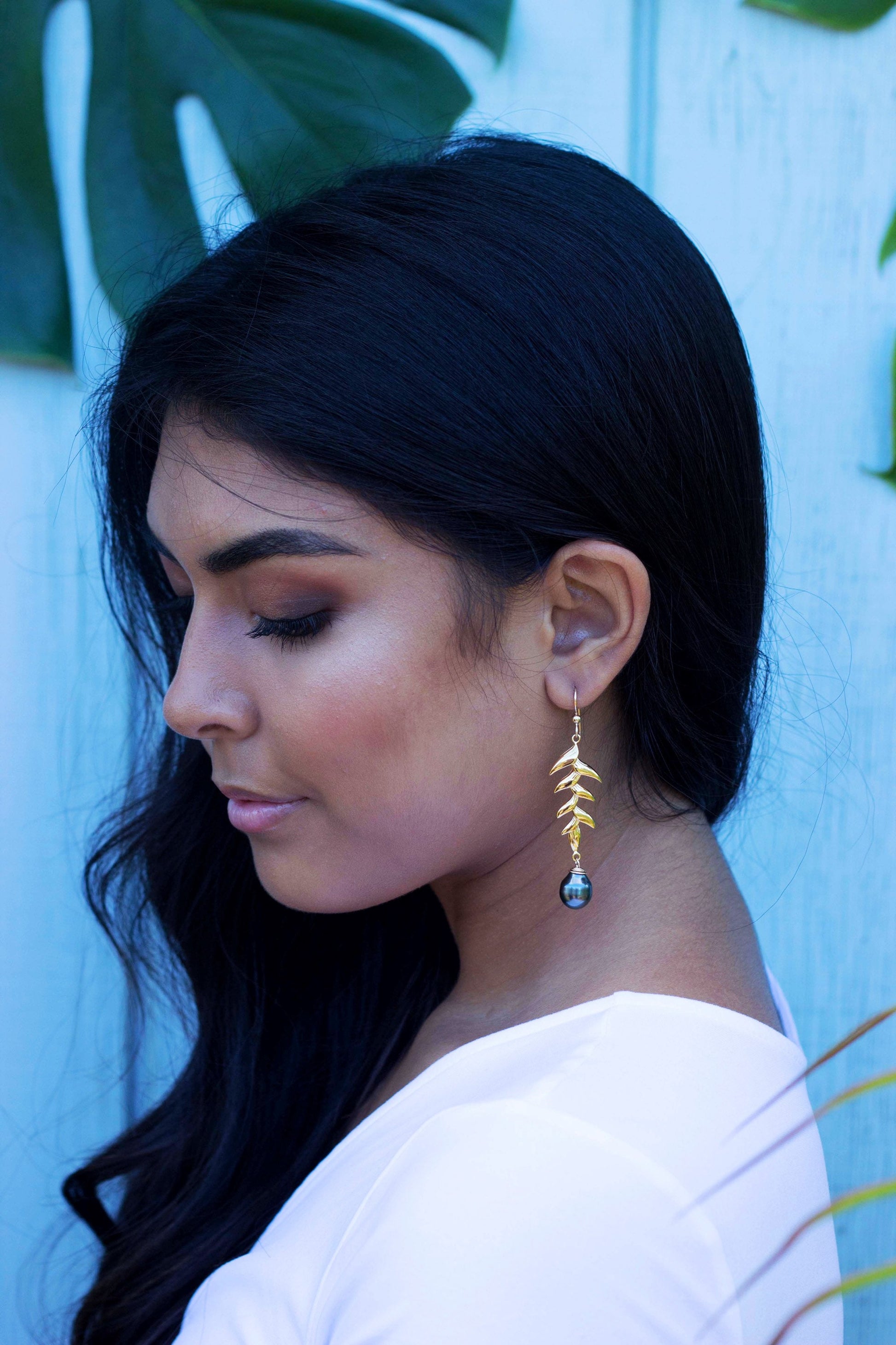 Hold heliconia earrings with tahitian black pearl