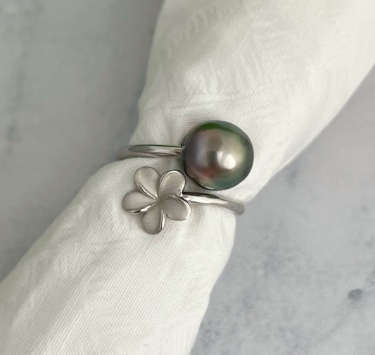Sterling silver wrap ring featuring a lustrous Tahitian pearl and a plumeria flower.