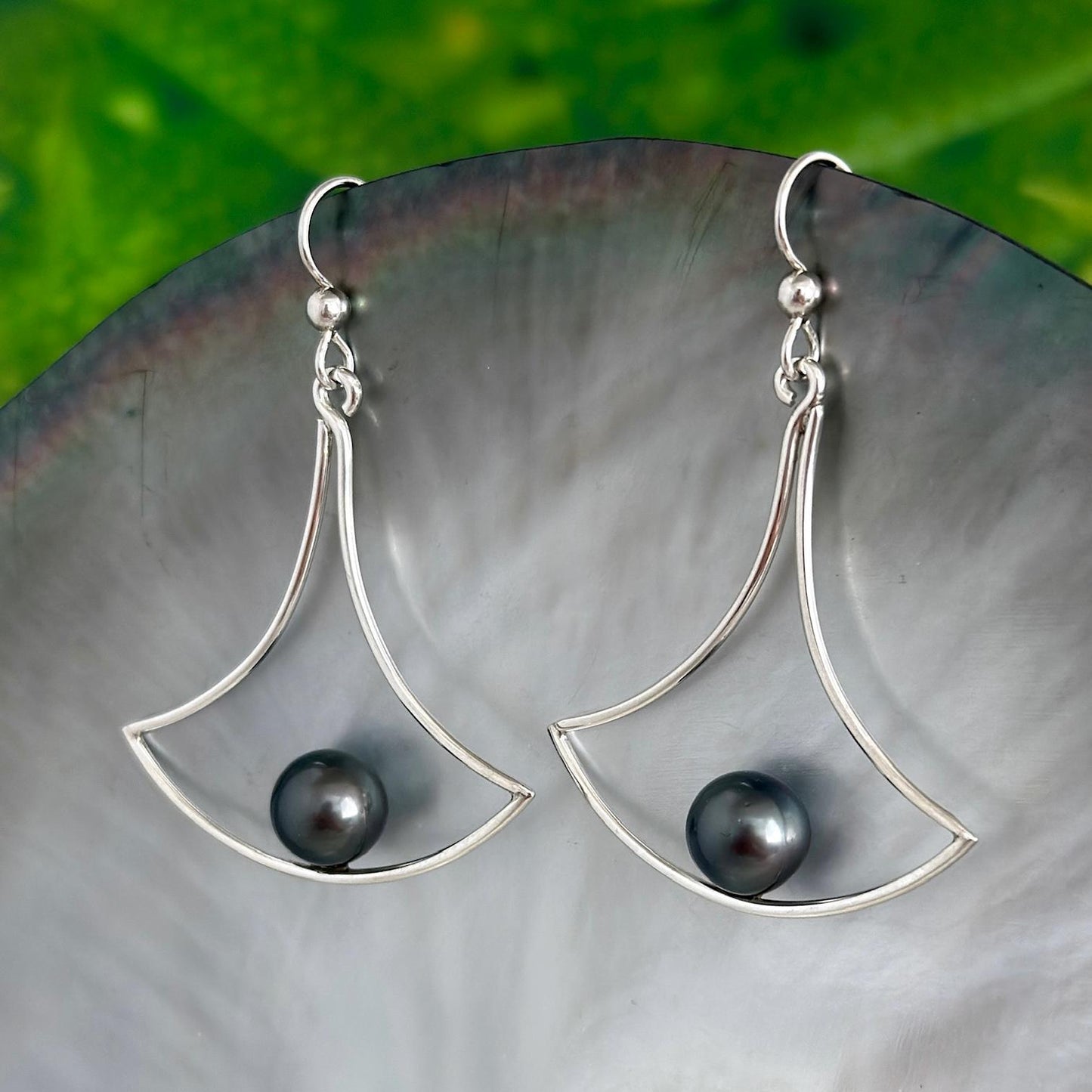 Sterling silver earrings with a modern fan-shaped open frame, featuring Tahitian pearls seated at the base of the design.