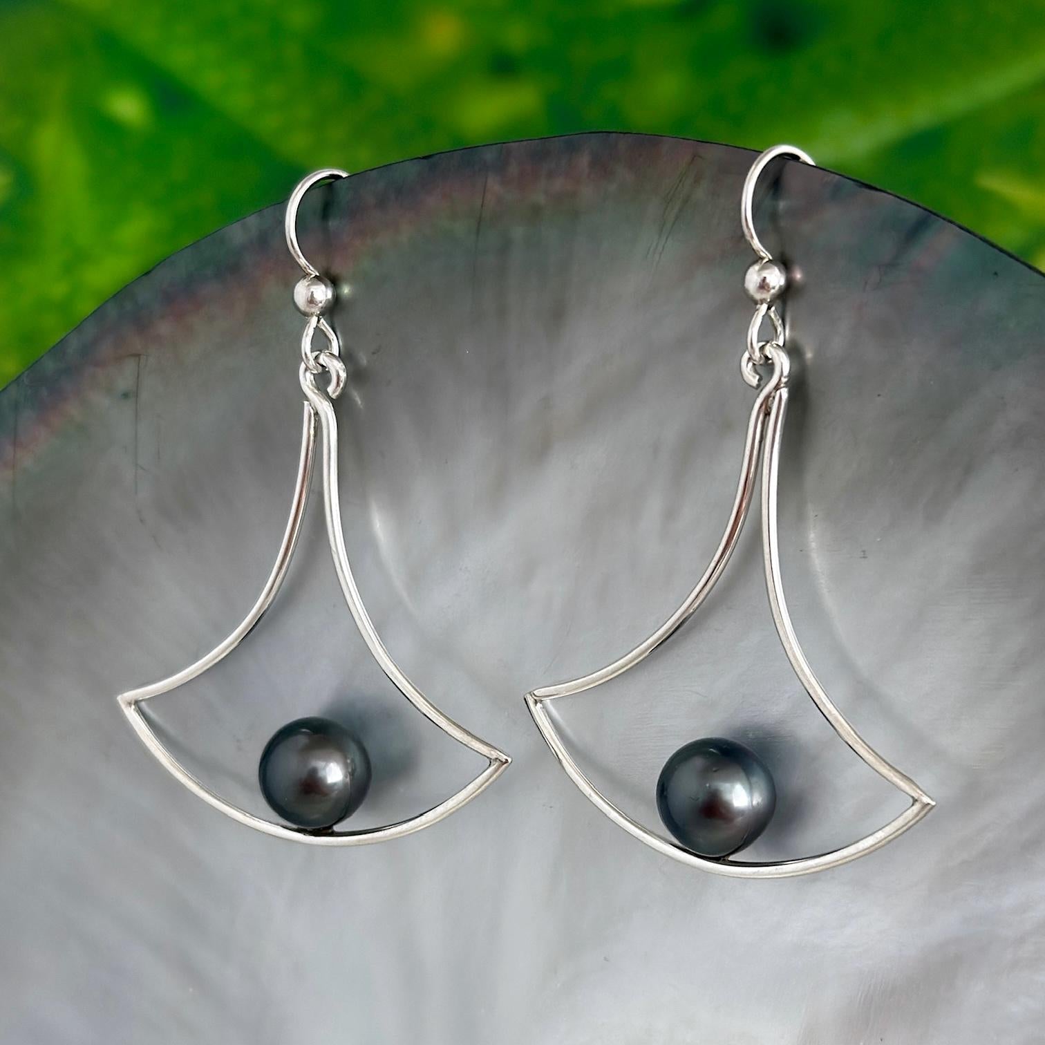 Sterling silver earrings with a modern fan-shaped open frame, featuring Tahitian pearls seated at the base of the design.