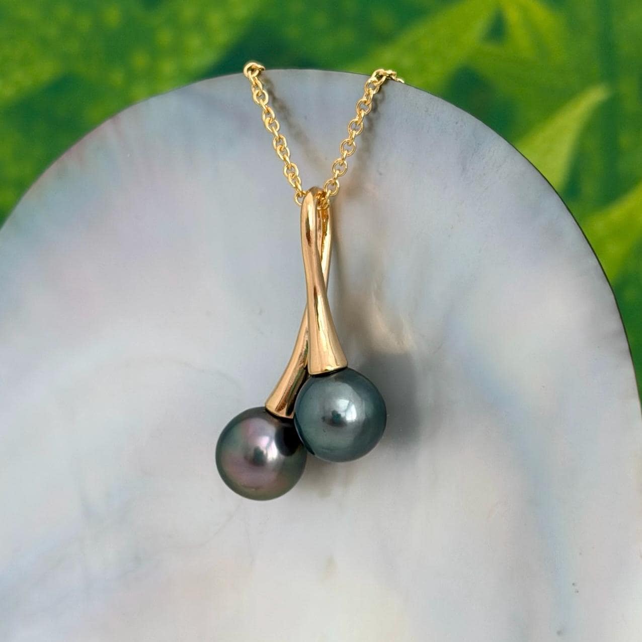 Double tahitian pearl pendant in 18k heavy yellow gold plated featuring a blue and a peacock pink and green pearl