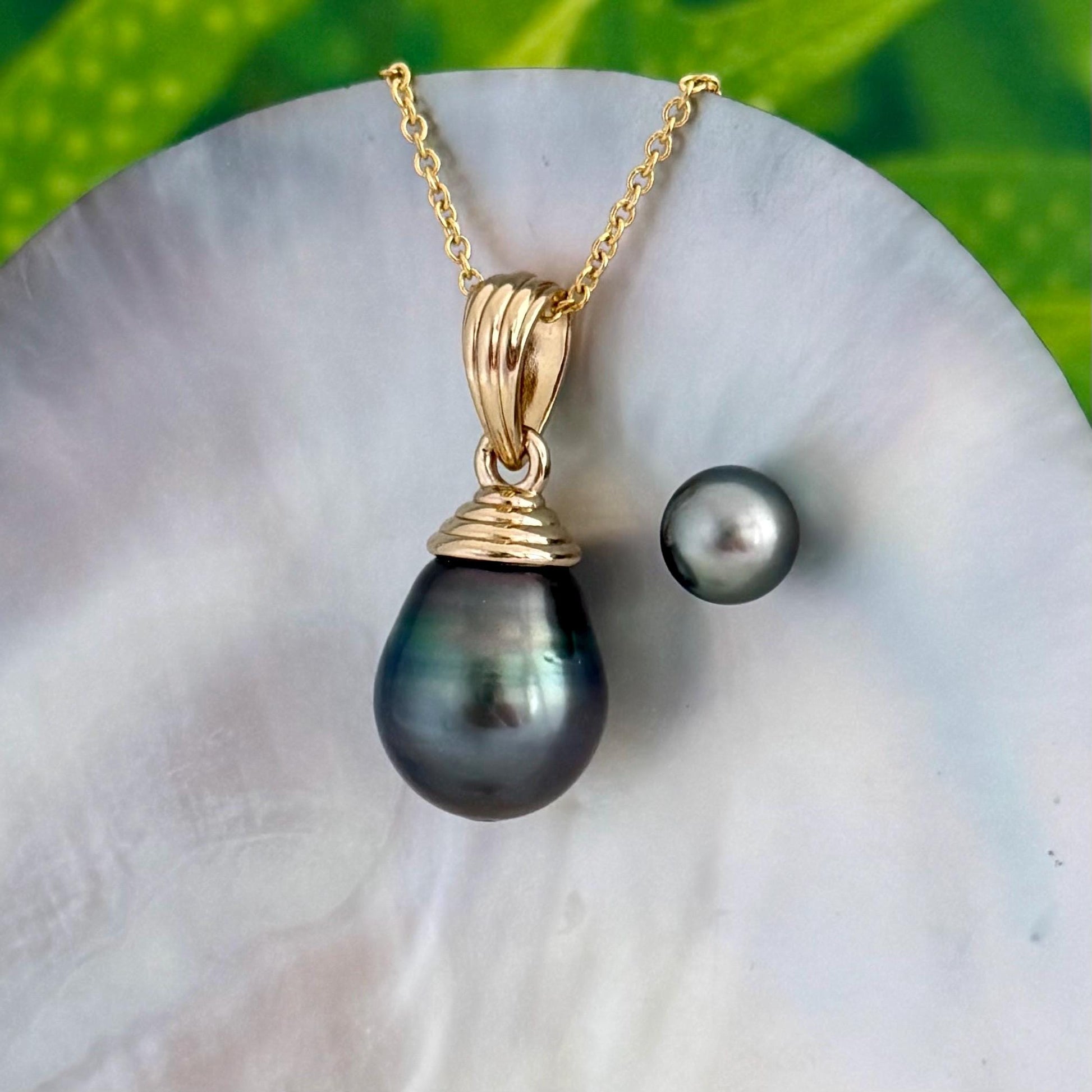 extra large tahitian pearl pendant with peacock blue pink and green overtones